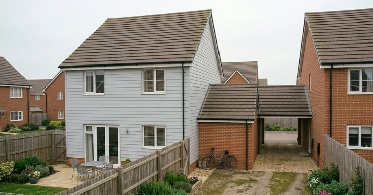 Estate agent board outside a suburban property